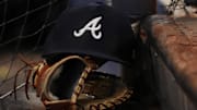 A general view of the cap and glove of Atlanta Braves first baseman Matt Olson (28) on the dugout steps in the ninth inning against the Miami Marlins at loanDepot park in Miami on Aug. 13, 2022.  