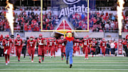 Nov 23, 2024; Louisville, Kentucky, USA;  The Louisville Cardinals mascot leads the team on the field before a game against the Pittsburgh Panthers at L&N Federal Credit Union Stadium. Mandatory Credit: Jamie Rhodes-Imagn Images
