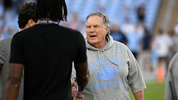 Sep 1, 2025; Chapel Hill, North Carolina, USA;  North Carolina Tar Heels head coach Bill Belichick with a recruit before the game at Kenan Stadium. Mandatory Credit: Bob Donnan-Imagn Images