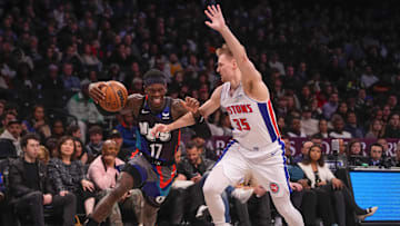 Apr 6, 2024; Brooklyn, New York, USA; Brooklyn Nets point guard Dennis Schroder (17) drives the ball against Detroit Pistons guard Buddy Boeheim (35) during the second half at Barclays Center. Mandatory Credit: Gregory Fisher-Imagn Images