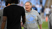 North Carolina Tar Heels head coach Bill Belichick with a recruit before the game at Kenan Stadium. 