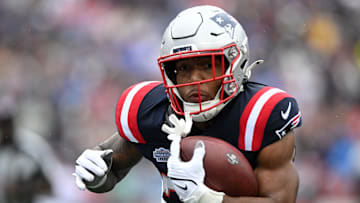 Sep 7, 2025; Foxborough, Massachusetts, USA; New England Patriots running back TreVeyon Henderson (32) rushes the ball against the Las Vegas Raiders in the first half at Gillette Stadium. Mandatory Credit: Brian Fluharty-Imagn Images