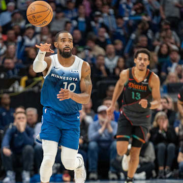 Minnesota Timberwolves guard Mike Conley (10) passes the ball up the court against the Washington Wizards in the fourth quarter at Target Center in Minneapolis on April 9, 2024.