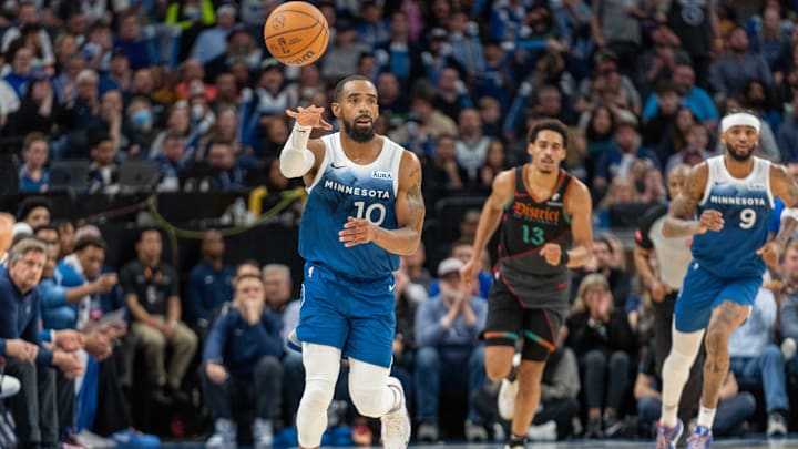 Minnesota Timberwolves guard Mike Conley (10) passes the ball up the court against the Washington Wizards in the fourth quarter at Target Center in Minneapolis on April 9, 2024.