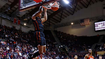 Jan 4, 2025; Blacksburg, Virginia, USA; Miami Hurricanes guard Matthew Cleveland (0) dunks the ball during the second half against the Virginia Tech Hokies at Cassell Coliseum. Mandatory Credit: Peter Casey-Imagn Images