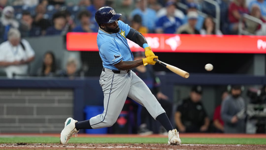 Jul 24, 2024; Toronto, Ontario, CAN; Tampa Bay Rays left fielder Randy Arozarena (56) hits a RBI single against the Toronto Blue Jays during the sixth inning at Rogers Centre. Mandatory Credit: Nick Turchiaro-USA TODAY Sports