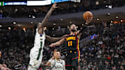 Mar 30, 2025; Milwaukee, Wisconsin, USA;  Atlanta Hawks guard Trae Young (11) shoots around Milwaukee Bucks forward Taurean Prince (12) during the third quarter at Fiserv Forum. Mandatory Credit: Jeff Hanisch-Imagn Images