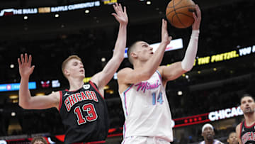Apr 9, 2025; Chicago, Illinois, USA; Chicago Bulls guard Kevin Huerter (13) defends Miami Heat guard Tyler Herro (14) during the second half at United Center. Mandatory Credit: David Banks-Imagn Images