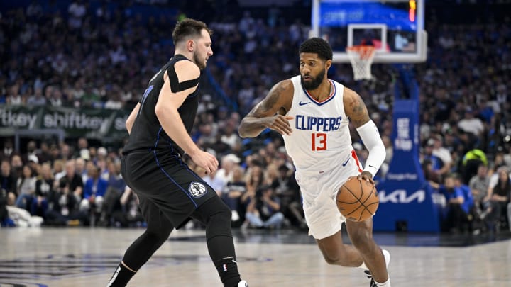 May 3, 2024; Dallas, Texas, USA; LA Clippers forward Paul George (13) moves the ball past Dallas Mavericks guard Luka Doncic (77) during the first quarter during game six of the first round for the 2024 NBA playoffs at American Airlines Center. Mandatory Credit: Jerome Miron-USA TODAY Sports