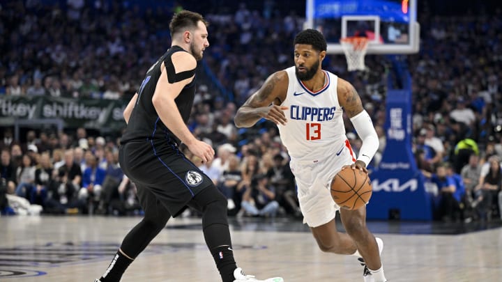 May 3, 2024; Dallas, Texas, USA; LA Clippers forward Paul George (13) moves the ball past Dallas Mavericks guard Luka Doncic (77) during the first quarter during game six of the first round for the 2024 NBA playoffs at American Airlines Center. Mandatory Credit: Jerome Miron-USA TODAY Sports