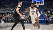 May 3, 2024; Dallas, Texas, USA; LA Clippers forward Paul George (13) moves the ball past Dallas Mavericks guard Luka Doncic (77) during the first quarter during game six of the first round for the 2024 NBA playoffs at American Airlines Center. Mandatory Credit: Jerome Miron-USA TODAY Sports