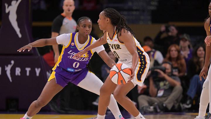 May 13, 2026; Los Angeles, California, USA;  Los Angeles Sparks guard Ta'niya Latson (0) defends Indiana Fever guard Kelsey Mitchell (0) in the first half at Crypto.com Arena. Mandatory Credit: Jayne Kamin-Oncea-Imagn Images