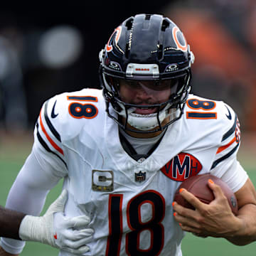 Chicago Bears quarterback Caleb Williams (18) runs by Cincinnati Bengals linebacker Oren Burks (42) in the fourth quarter of the NFL football game between Chicago Bears and Cincinnati Bengals at Paycor Stadium in Cincinnati on Nov. 2, 2025.