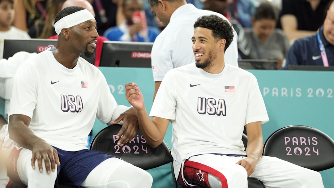 United States centee Bam Adebayo and guard Tyrese Haliburton watch from the sidelines during play at the 2024 Olympics.