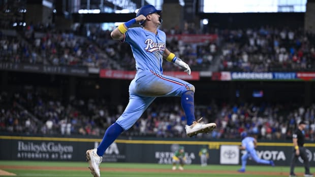 Texas Rangers slugger Josh Jung waves his walk-off home run over the fence.