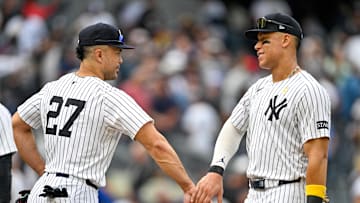 Sep 7, 2025; Bronx, New York, USA; New York Yankees designated hitter Giancarlo Stanton (27) celebrates with New York Yankees right fielder Aaron Judge (99) after the game against the Toronto Blue Jays at Yankee Stadium. Mandatory Credit: Mark Smith-Imagn Images