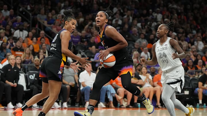Aug 15, 2025; Phoenix, Arizona, USA; Phoenix Mercury forward Alyssa Thomas (25) drives between forward Satou Sabally (0) and Las Vegas Aces guard Jewell Loyd (24) in the second half at Footprint Center. Mandatory Credit: Rick Scuteri-Imagn Images