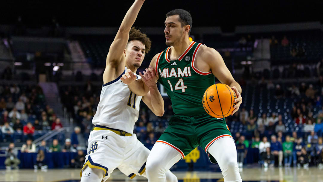 Jan 13, 2026; South Bend, Indiana, USA; Miami (FL) Hurricanes guard Noam Dovrat (14) drives against Notre Dame Fighting Irish guard Braeden Shrewsberry (11) during the second half at Purcell Pavilion at the Joyce Center. Mandatory Credit: Michael Caterina-Imagn Images