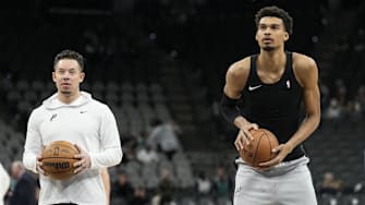 Jan 15, 2025; San Antonio, Texas, USA; San Antonio Spurs interim coach Mitch Johnson looks on as center Victor Wembanyama (1) shoots free throws before a game against the Memphis Grizzlies at Frost Bank Center. Mandatory Credit: Scott Wachter-Imagn Images