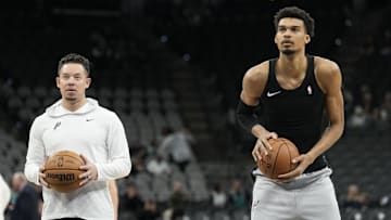 Jan 15, 2025; San Antonio, Texas, USA; San Antonio Spurs interim coach Mitch Johnson looks on as center Victor Wembanyama (1) shoots free throws before a game against the Memphis Grizzlies at Frost Bank Center. Mandatory Credit: Scott Wachter-Imagn Images