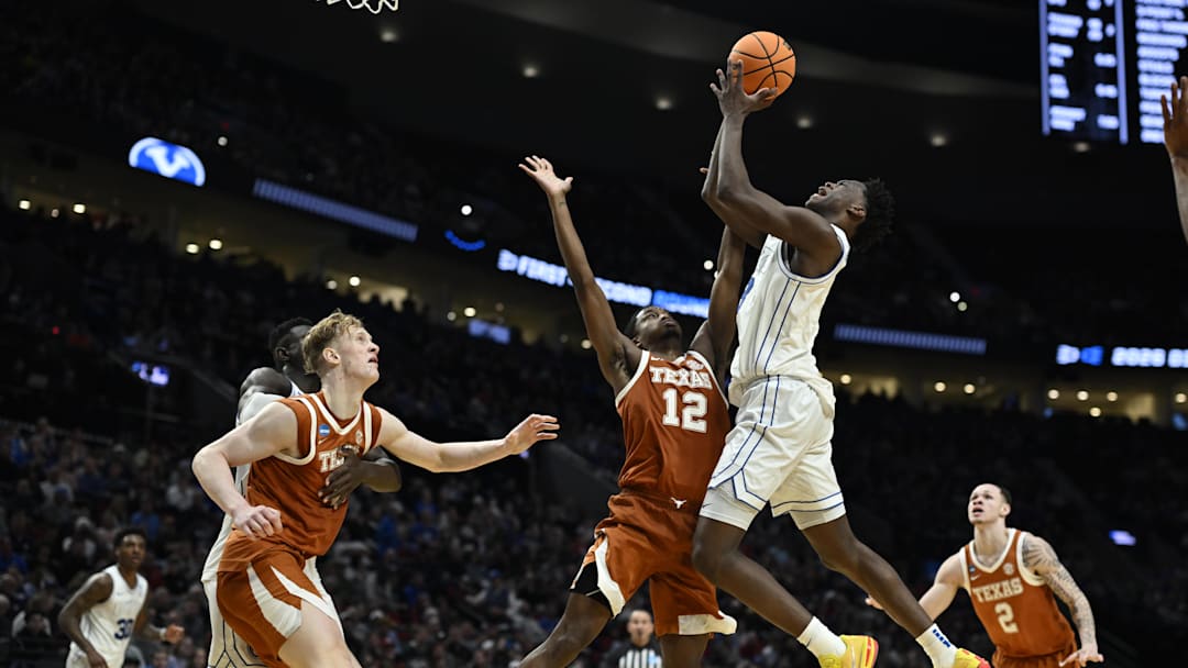 Mar 19, 2026; Portland, OR, USA; BYU Cougars forward AJ Dybantsa (3) shoots against Texas Longhorns guard Tramon Mark (12) in the second half during a first round game of the men's 2026 NCAA Tournament at Moda Center. Mandatory Credit: Troy Wayrynen-Imagn Images