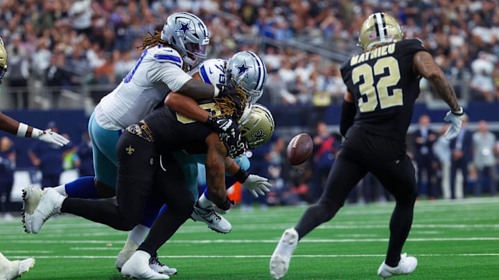 Sep 15, 2024; Arlington, Texas, USA; Dallas Cowboys offensive tackle Terence Steele (78) and New Orleans Saints defensive tackle Bryan Bresee (90) and New Orleans Saints safety Tyrann Mathieu (32) go for a fumble during the second half  at AT&T Stadium. Mandatory Credit: Kevin Jairaj-Imagn Images