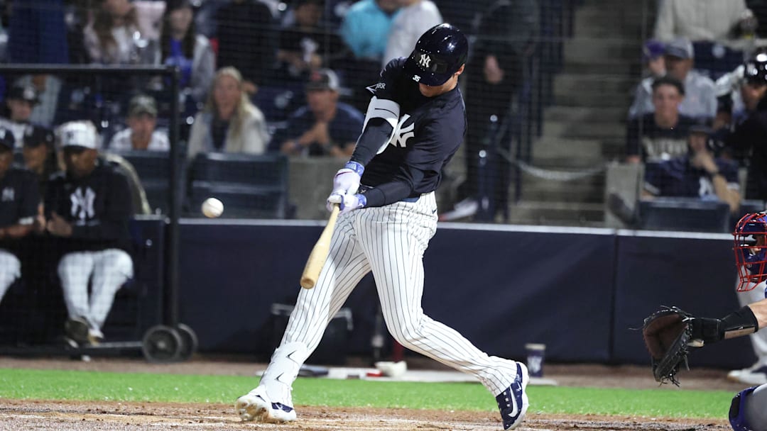 Mar 7, 2025; Tampa, Florida, USA; New York Yankees outfielder Cody Bellinger (35) hits a home run during the first inning against the Toronto Blue Jays at George M. Steinbrenner Field. 