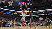 Nov 15, 2025; Louisville, Kentucky, USA;  Louisville Cardinals guard Ryan Conwell (3) shoots against Ohio Bobcats forward Ayden Evans (5) during the first half at KFC Yum! Center. Mandatory Credit: Jamie Rhodes-Imagn Images