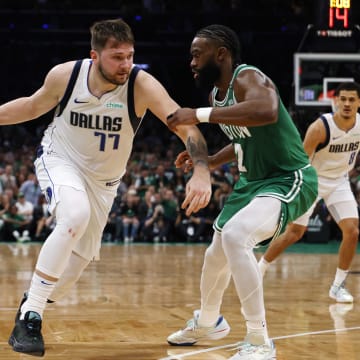 Jun 17, 2024; Boston, Massachusetts, USA; Dallas Mavericks guard Luka Doncic (77) dribbles the ball against Boston Celtics guard Jaylen Brown (7) during the second quarter in game five of the 2024 NBA Finals at TD Garden. Mandatory Credit: Peter Casey-USA TODAY Sports