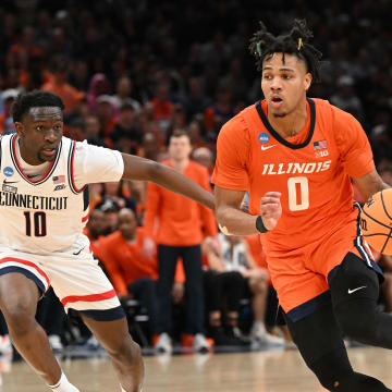 Mar 30, 2024; Boston, MA, USA; Illinois Fighting Illini guard Terrence Shannon Jr. (0) dribbles the ball against Connecticut Huskies guard Hassan Diarra (10) in the finals of the East Regional of the 2024 NCAA Tournament at TD Garden. Mandatory Credit: Brian Fluharty-USA TODAY Sports