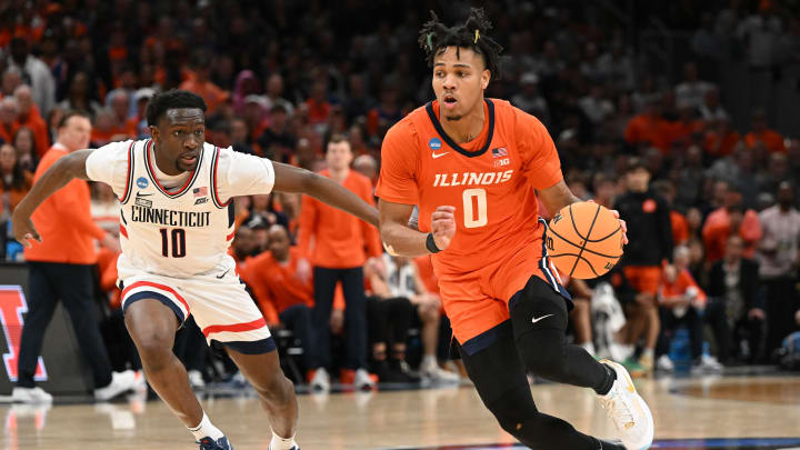 Mar 30, 2024; Boston, MA, USA; Illinois Fighting Illini guard Terrence Shannon Jr. (0) dribbles the ball against Connecticut Huskies guard Hassan Diarra (10) in the finals of the East Regional of the 2024 NCAA Tournament at TD Garden.