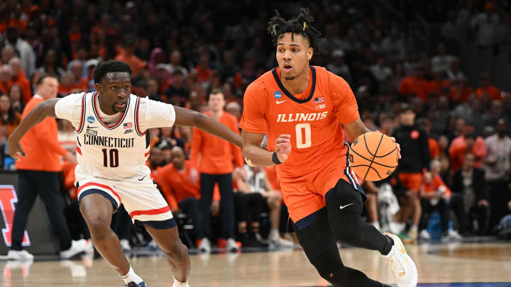 Mar 30, 2024; Boston, MA, USA; Illinois Fighting Illini guard Terrence Shannon Jr. (0) dribbles the ball against Connecticut Huskies guard Hassan Diarra (10) in the finals of the East Regional of the 2024 NCAA Tournament at TD Garden. Mandatory Credit: Brian Fluharty-USA TODAY Sports