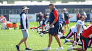 New England Patriots head coach Mike Vrabel and coordinator Josh McDaniels talk during training camp at Gillette Stadium