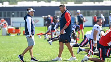 New England Patriots head coach Mike Vrabel and coordinator Josh McDaniels talk during training camp at Gillette Stadium
