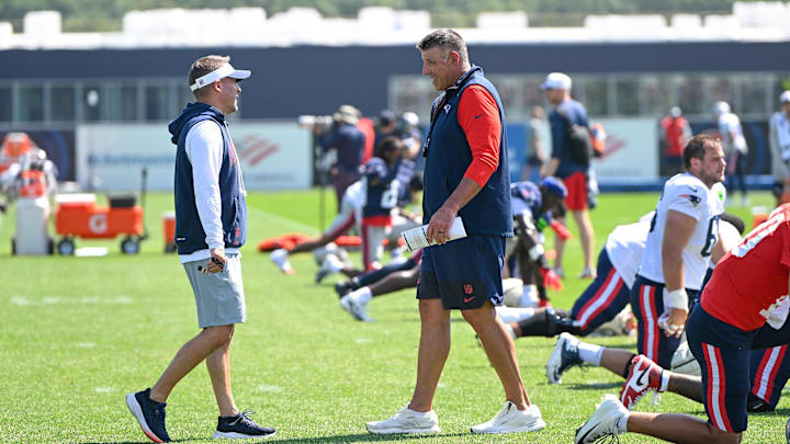 New England Patriots head coach Mike Vrabel and coordinator Josh McDaniels talk during training camp at Gillette Stadium