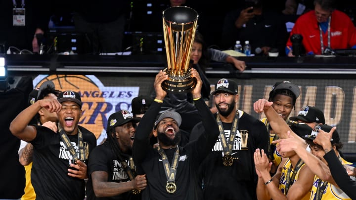 Dec 9, 2023; Las Vegas, Nevada, USA; Los Angeles Lakers forward LeBron James (23) hoists the NBA Cup and celebrates with teammates after winning the NBA In-Season Tournament Championship game against the Indiana Pacers at T-Mobile Arena. Mandatory Credit: Candice Ward-USA TODAY Sports