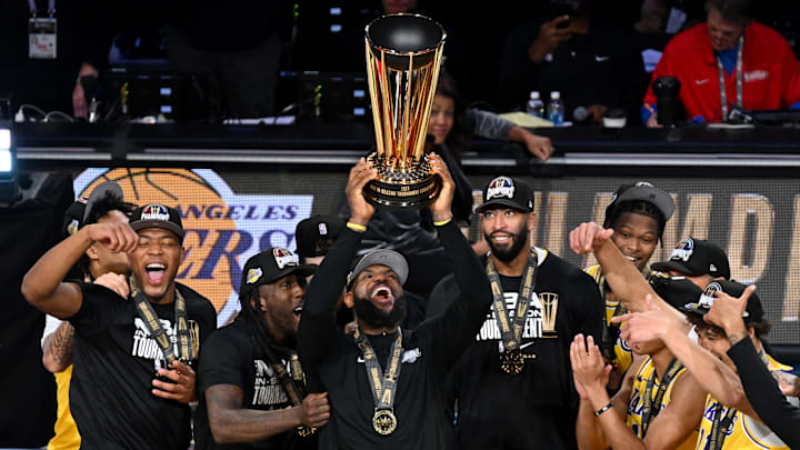 James hoists the NBA Cup for the Lakers in 2023.