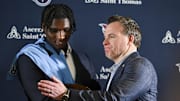 Tennessee Titans first round pick Cameron Ward shakes hands with the Tennessee Titans general manager Mike Borgonzi during the Tennessee Titans press conference. 