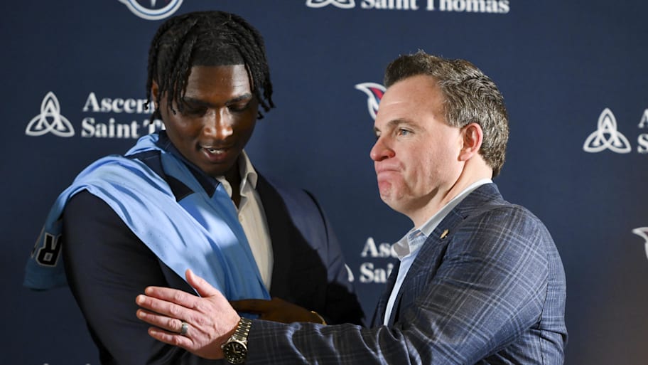 Tennessee Titans first round pick Cameron Ward shakes hands with the Tennessee Titans general manager Mike Borgonzi.