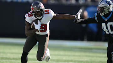 Jan 7, 2024; Charlotte, North Carolina, USA; Tampa Bay Buccaneers wide receiver Rakim Jarrett (18) rushes the ball against Carolina Panthers linebacker Deion Jones (40) during the second quarter at Bank of America Stadium. Mandatory Credit: Jim Dedmon-Imagn Images