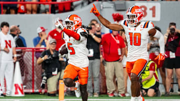 Sep 20, 2024; Lincoln, Nebraska, USA; Illinois Fighting Illini defensive back Torrie Cox Jr. (5) and defensive back Miles Scott (10) celebrate after an interception in the end zone against the Nebraska Cornhuskers during the second quarter at Memorial Stadium. Mandatory Credit: Dylan Widger-Imagn Images