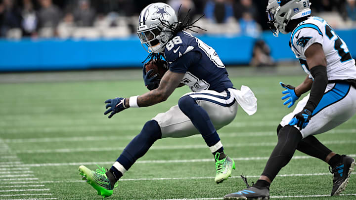 Dallas Cowboys wide receiver CeeDee Lamb with the ball as Carolina Panthers safety Jordan Fuller.