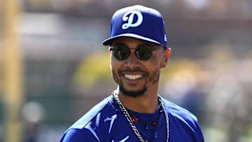 Mar 8, 2025; Phoenix, Arizona, USA; Los Angeles Dodgers shortstop Mookie Betts (50) warms up before a game against the Chicago White Sox at Camelback Ranch-Glendale.