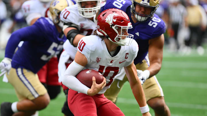 Sep 14, 2024; Seattle, Washington, USA; Washington State Cougars quarterback John Mateer (10) carries the ball against the Washington Huskies during the first half at Lumen Field. Mandatory Credit: Steven Bisig-Imagn Images