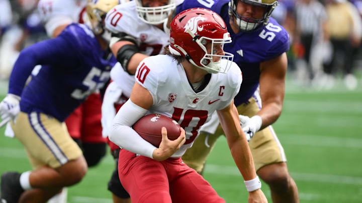 Sep 14, 2024; Seattle, Washington, USA; Washington State Cougars quarterback John Mateer (10) carries the ball against the Washington Huskies during the first half at Lumen Field. Mandatory Credit: Steven Bisig-Imagn Images