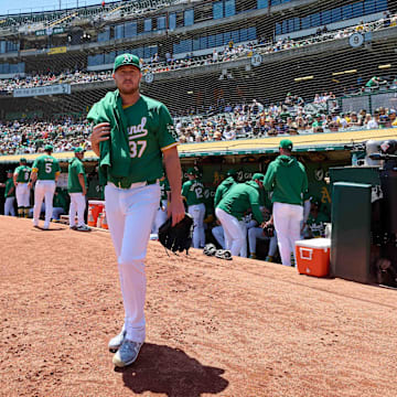 May 26, 2024; Oakland, California, USA; Oakland Athletics pitcher Jack O'Loughlin (37) walks to the bullpen before the start of the game against the Houston Astros at Oakland-Alameda County Coliseum. Mandatory Credit: Robert Edwards-Imagn Images