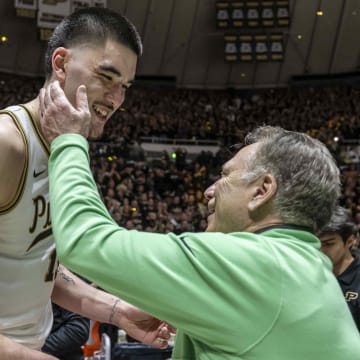 Purdue center Zach Edey shares a moment after the game with Michigan State coach Tom Izzo 