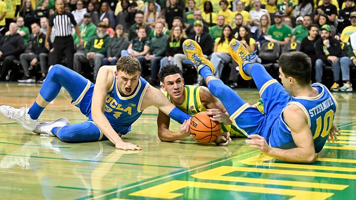 Dec 8, 2024; Eugene, Oregon, USA; Oregon Ducks guard Jackson Shelstad (3) battles for the ball against  UCLA Bruins forward Tyler Bilodeau (34) and guard Lazar Stefanovic (10) in the first half at Matthew Knight Arena.