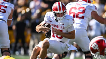 Sep 27, 2025; Iowa City, Iowa, USA; Indiana Hoosiers quarterback Fernando Mendoza (15) is sacked by Iowa Hawkeyes defensive lineman Aaron Graves (95) during the first quarter at Kinnick Stadium. Mandatory Credit: Jeffrey Becker-Imagn Images