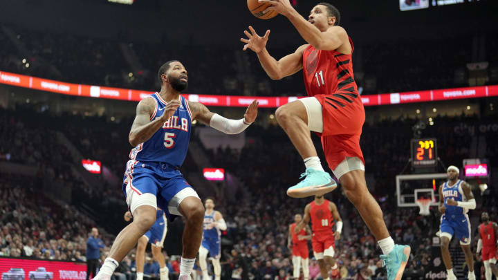 Jan 29, 2024; Portland, Oregon, USA; Portland Trail Blazers point guard Malcolm Brogdon (11) drives to the basket against Philadelphia 76ers small forward Marcus Morris Sr. (5) during the first half at Moda Center. Mandatory Credit: Soobum Im-USA TODAY Sports